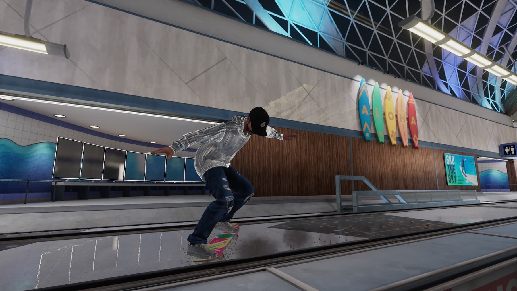 A skateboarder grinding a rail in an airport. In the background are five surfboards that spell Aloha