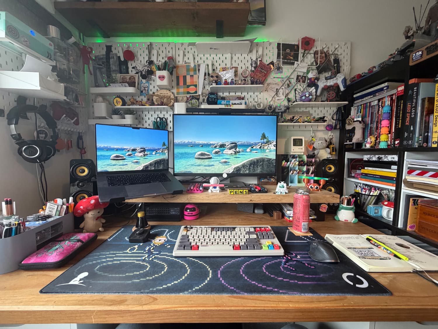 A desk with lots of stuff on it including pegboard behind it with photos and other nick nacks