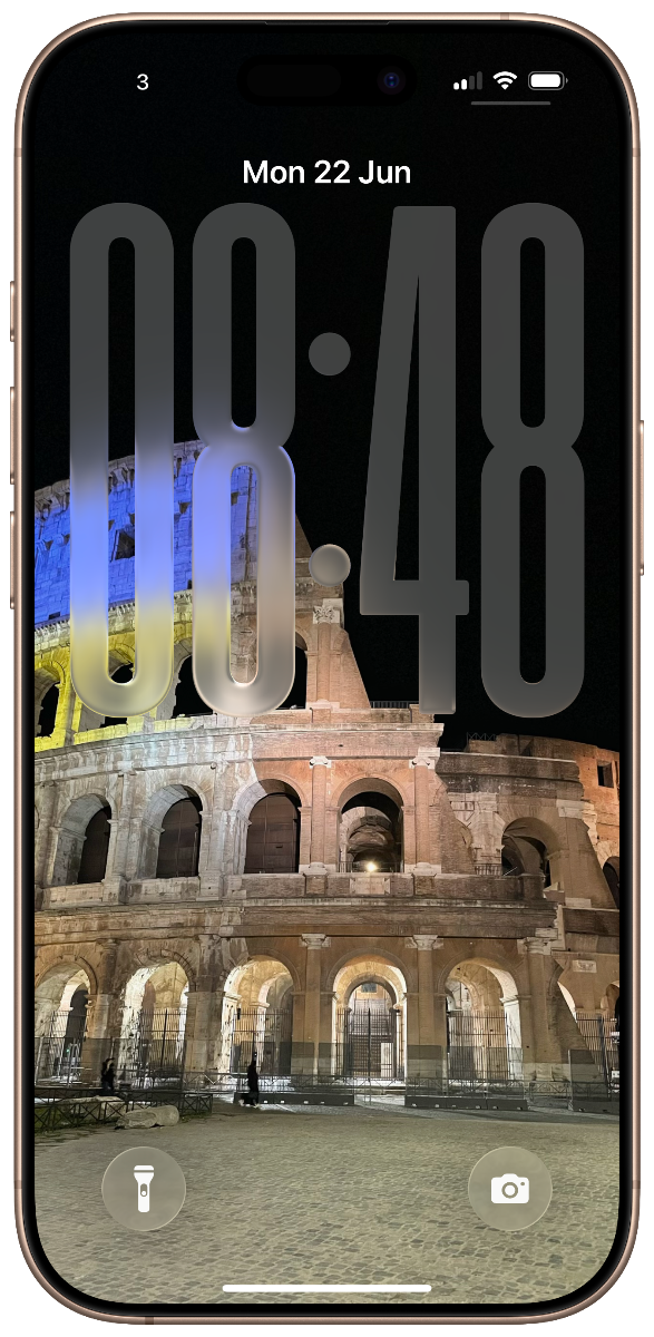 A phone home screen showing the Colosseum in Rome at night