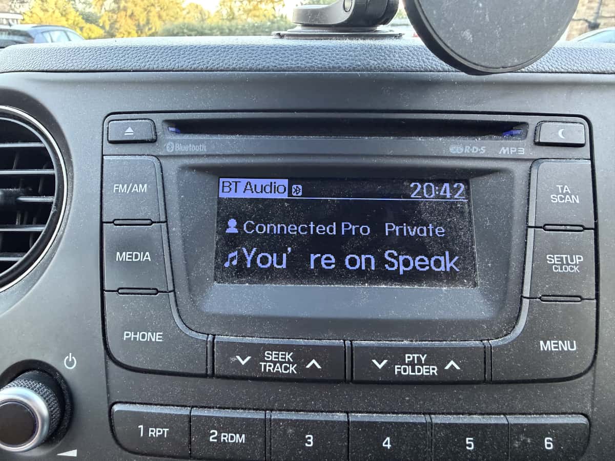 A car entertainment system showing a podcast. The space between one of the letters and an apostophe is huge