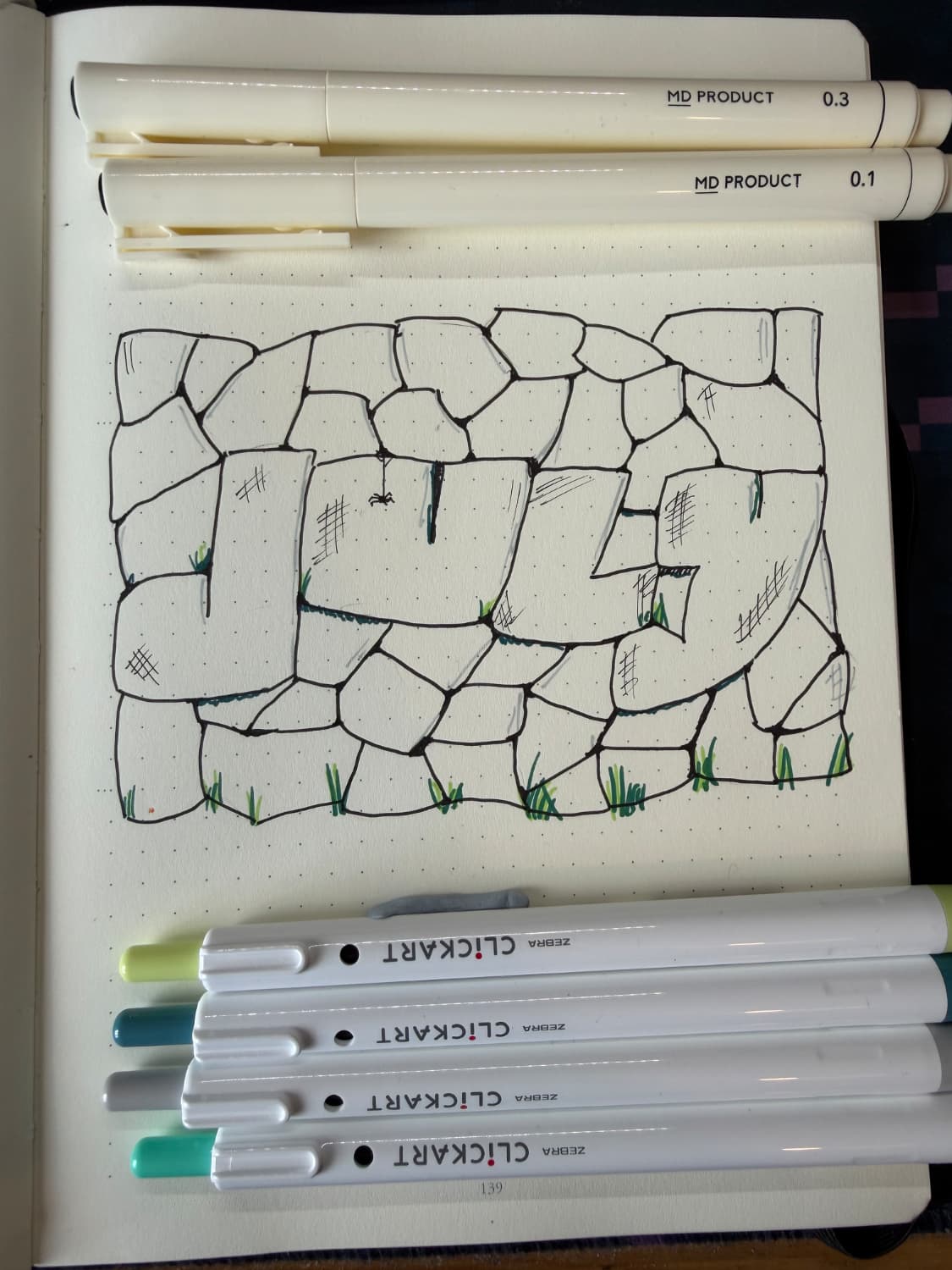 A hand drawn brick wall that says July in the bricks