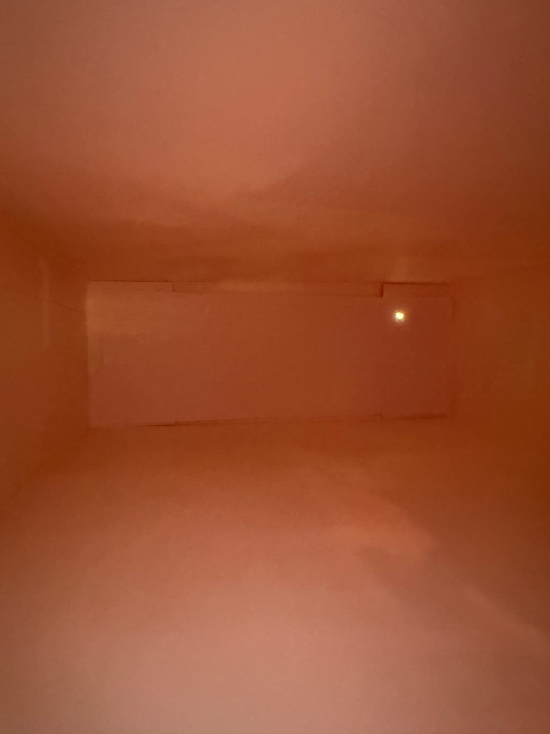 the inside of a pinhole camera. It looks like an empty room