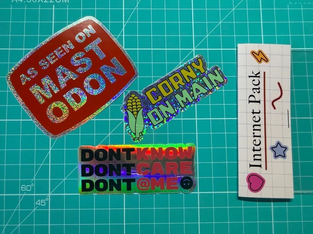 A pack of stickers. The cardboard says Internet Pack and you can see the stickers inside which say As seen on mastodon, don't know, and corny on main